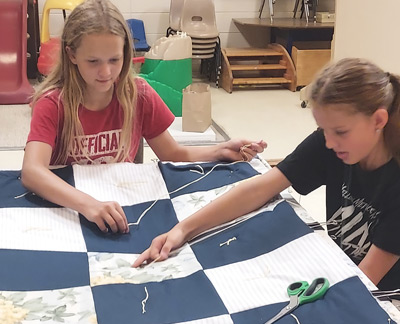 Cheryl's granddaughters quilting at church